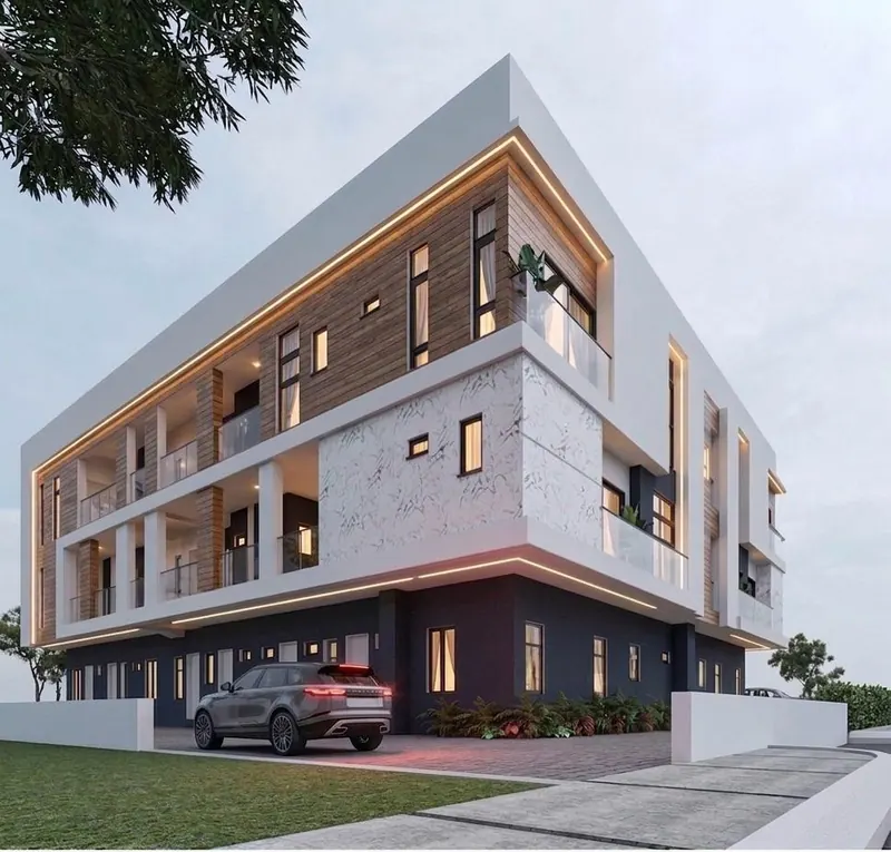 Dusk view of the 17-unit apartment building with warm facade lighting